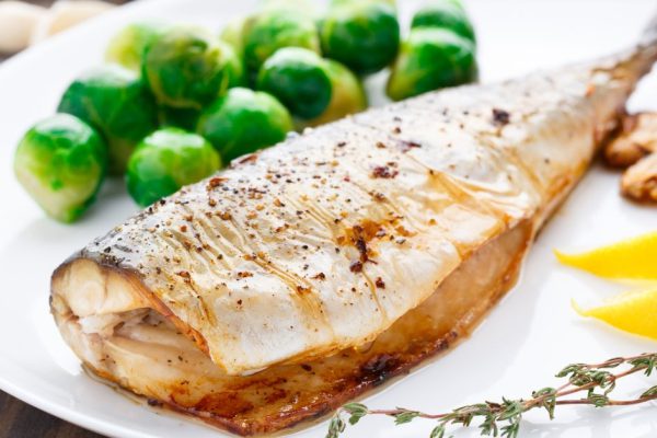 Delicious baked mackerel on a white plate