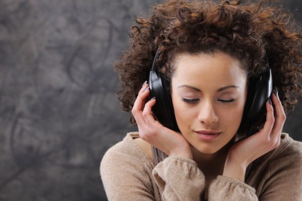 Young beautiful woman listening to music with headphones