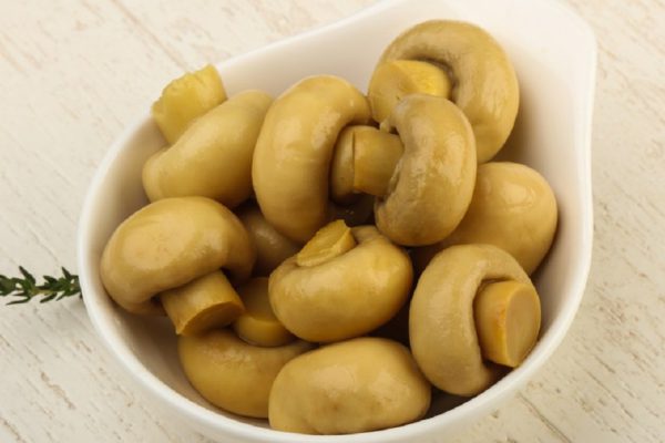 Marinated champignons in the bowl - ready for cooking