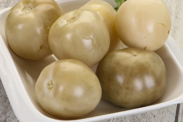 Pickled green tomatoes in the bowl