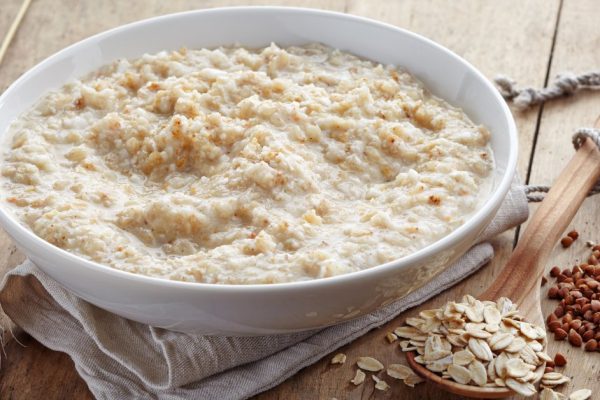 Bowl of various flakes porridge on wooden table
