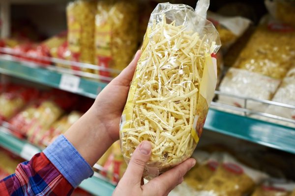 Buyer with a package pasta in the shop