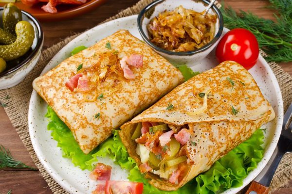 Savory pancakes stuffed with mashed potatoes, pickles and bacon. Traditional Russian food