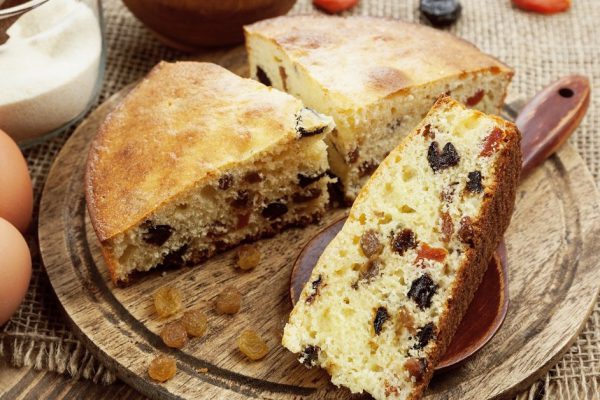 Semolina cake with dried fruits on a cutting board. Mannik