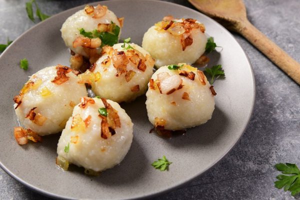 Meat stuffed potato dumplings with fried onion  and greaves on top