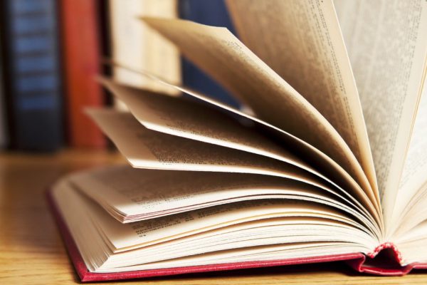 A pile of books with library on the back