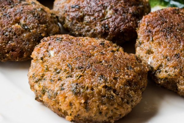 Homemade Salmon Meatballs Served with Orange Salad. Fast Food.