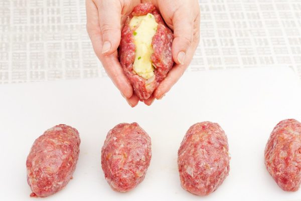 cooking meat cutlets stuffed with mashed potatoes closeup