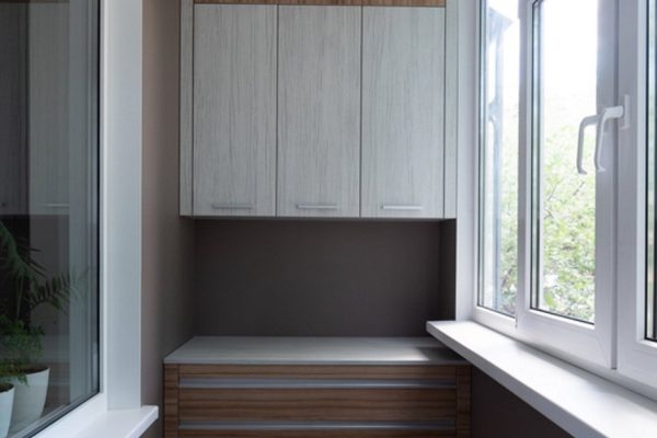 Balcony (loggia) after repair. New furniture in the room: chest of drawers and a wall cabinet