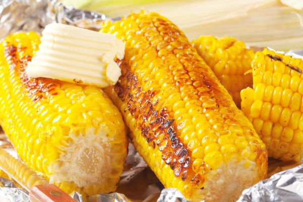 Pieces of sweet corn grilled in tin foil