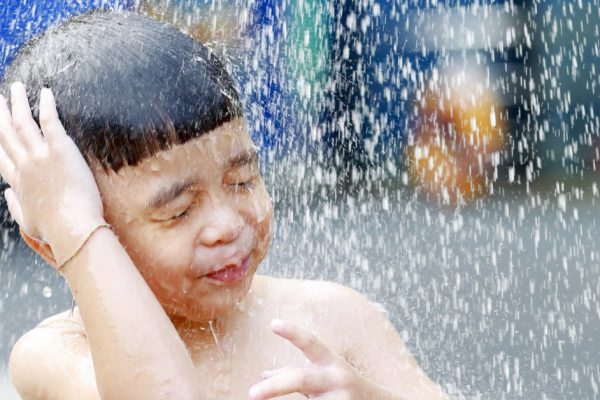 Kid boy playing with water during take shower