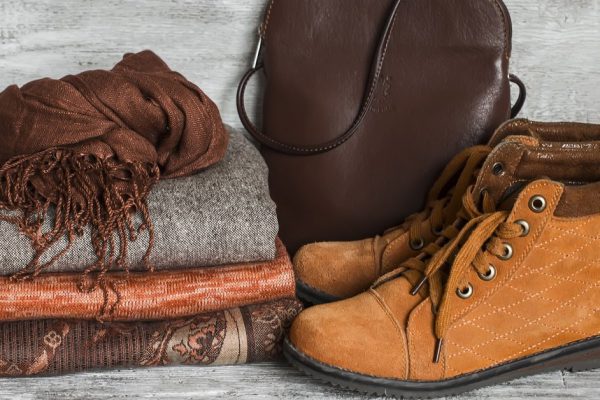 Women's clothing and accessories - skirt, turtleneck, scarf, shoes, bag, bright wooden surface