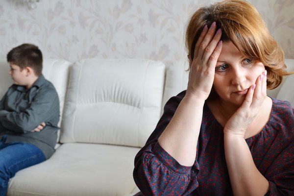 Mother and son after quarrel sit on the couch