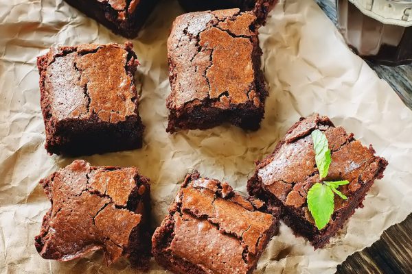 brownie on a dark wood background. tinting. selective focus on mint