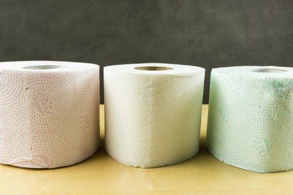 Three rolls of soft toilet paper in various colors (red, white, green)