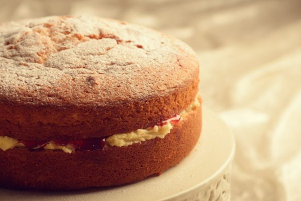 Freshly baked Victoria sponge cake filled with jam and buttercream