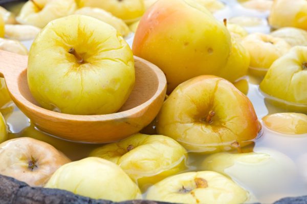 Pickled apples in an old wooden barrel.