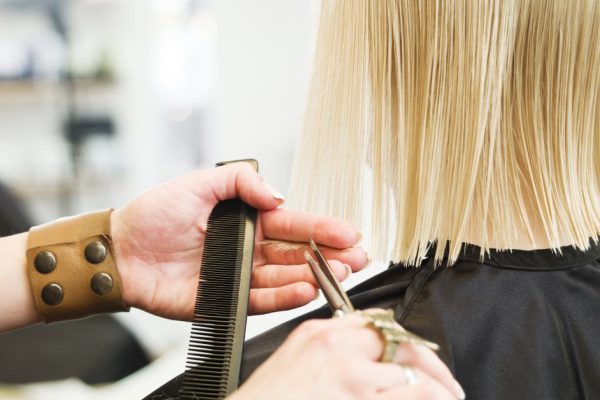 Close up of a scissor in a ction at the Hair Salon