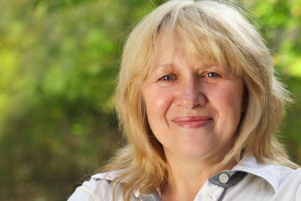 Middle aged woman looking at camera with happy smile