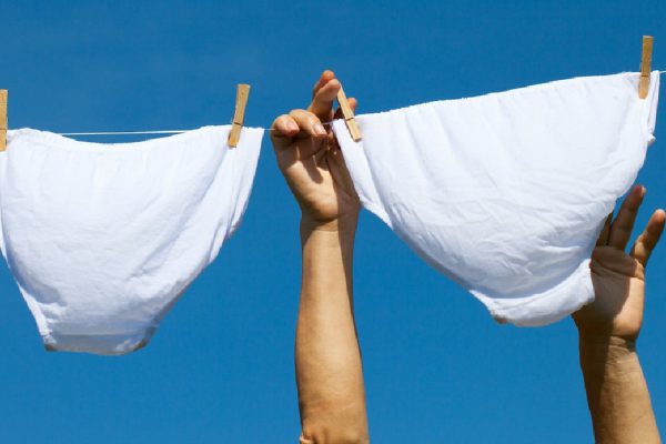 Underwear on clothesline against blue sky.