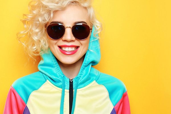 Fashion girl in sportswear on yellow background