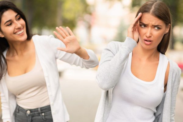 Girl Avoiding Meeting Toxic Friend Girl Ignoring Her Greeting Walking In Park Outdoors. Selective Focus