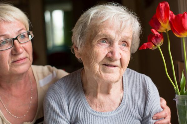 Portrait of an elderly woman with adult daughter.