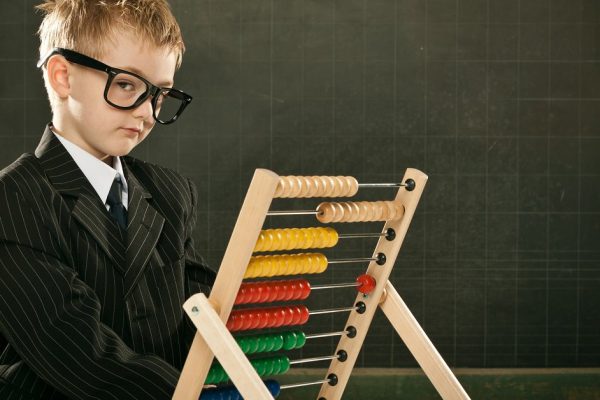 young clever scientist children students with abacus and blackboard