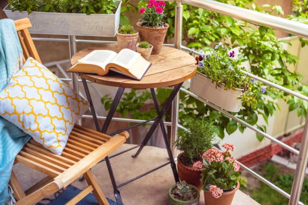 Beautiful terrace or balcony with small table, chair and flowers