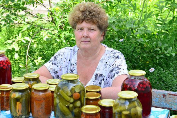 Mature housewife with a canned food for the winter
