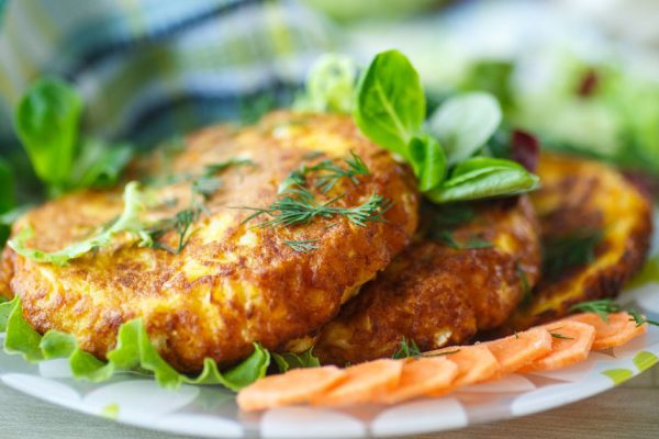 carrot fritters with herbs on a plate