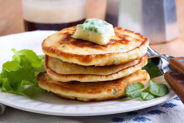 Sweetcorn pancakes with herb butter on plate