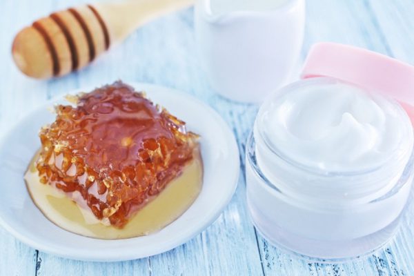 body lotion in glass bank and on a table