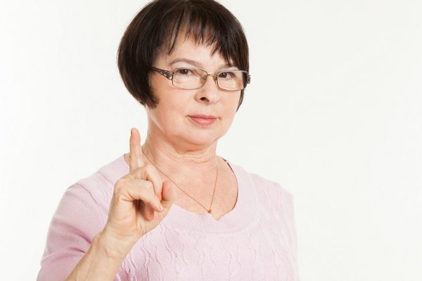 the beautiful mature woman with a severe look wearing spectacles