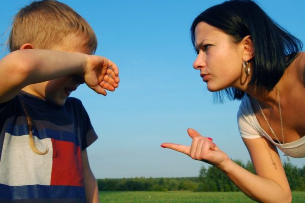 Young mother scolds her son
