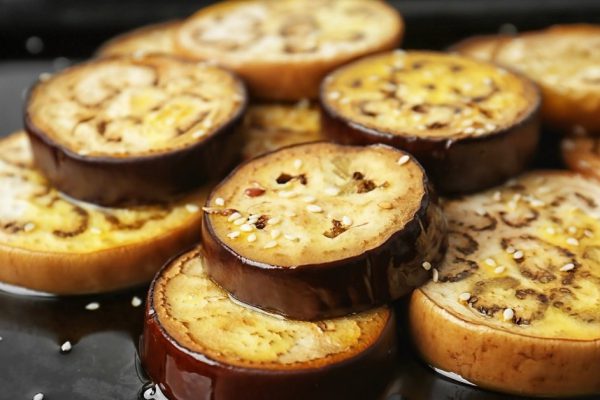 Sliced eggplant on baking tray, closeup