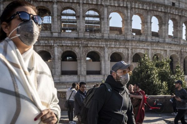 ROME, ITALY - FEBRUARY 24: Tourists wearing face masks visit the Colosseum area on February 24, 2020 in Rome, Italy. The Italian government declared a state of emergency on January 31 and today the coronavirus (Covid-19) has claimed its sixth victim in Italy, an 80-year-old man from Castiglione d'Adda who died in Milan's Sacco Hospital. (Photo by Antonio Masiello/Getty Images)