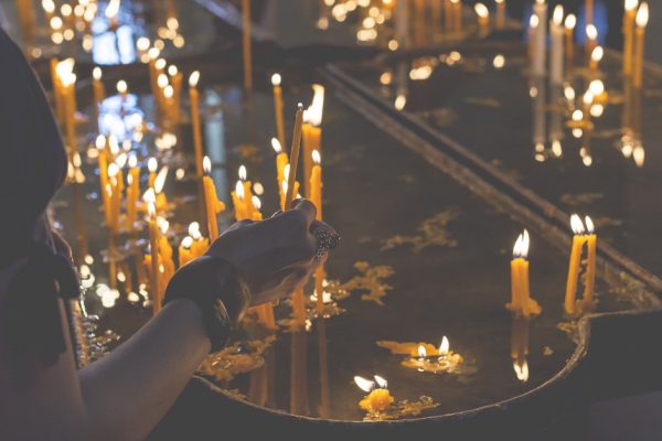 Burning candles in a church on a dark background