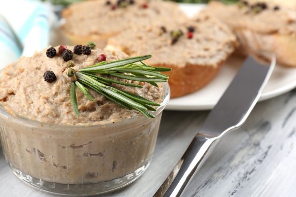 Fresh pate with bread on wooden table