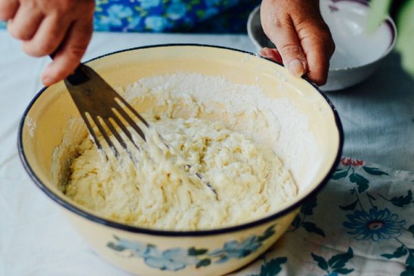 The woman is cooking pancakes. Spiced butternut squash ancakes.
Spiced butternut squash pancakes with potatos and apple. Cooking pancakes for breakfast