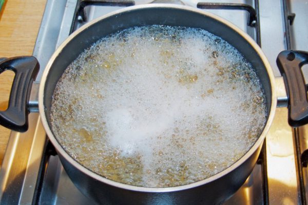 Boiling water inside a kitchen iron pot