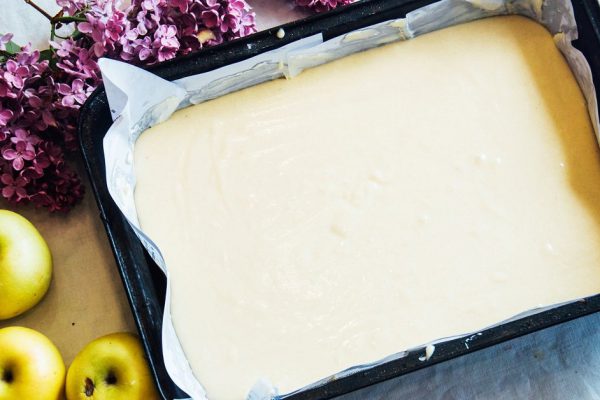 A woman prepares a pie apple tree, the ingredients for the cake: flour, egg, vanilla, sugar, milk, sour cream, soda. The girl in the kitchen. Women's hands. Preparation of Desserts for breakfast
