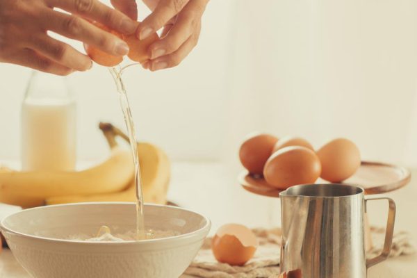 recipe ingredients : eggs, flour, milk, almonds, banana on white background