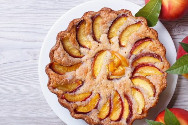 peach pie and fresh fruit on a wooden background horizontal view from above