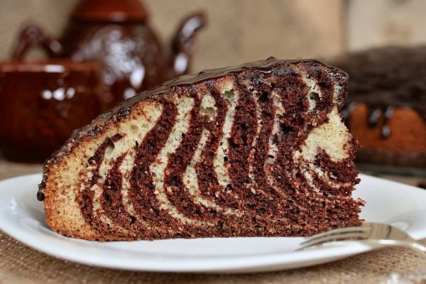 Pie Zebra with chocolate icing on wooden table