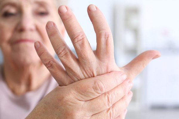 Elderly woman suffering from pain in hand, closeup