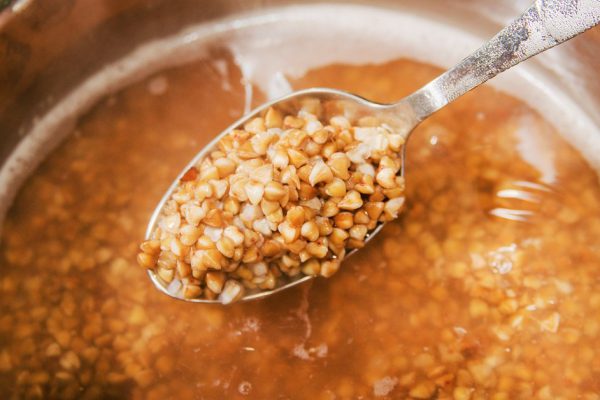 Buckwheat noodles being cooked in boiling water