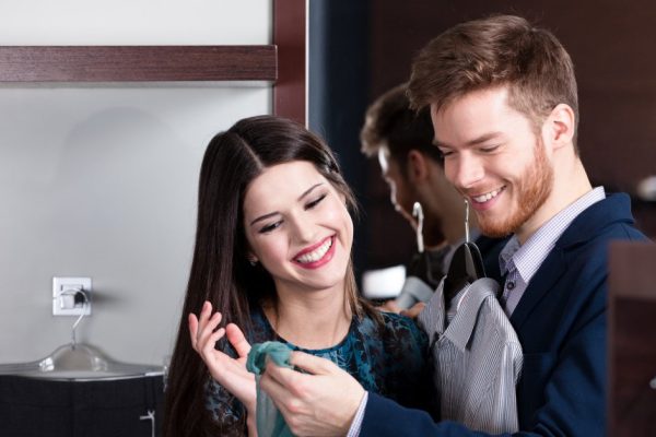 Beautiful couple looks at purchases in the shop