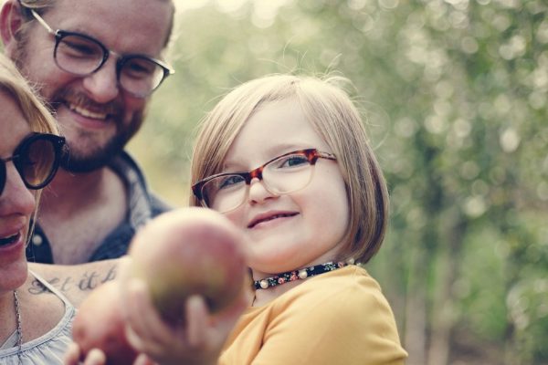 A Caucasian family is spending time at the farm together