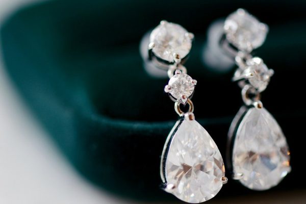 Beautiful wedding jewel for bride and groom. Beauty of wedding accessories indoors. Close-up bridal details of marriage. Female and male decoration for couple. Jewelry for man and woman